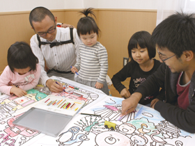 和歌山城などが描かれた巨大ぬりえを楽しむ親と子どもたち